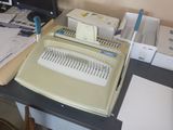a desk with a computer and a printer on it