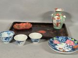 a tray with bowls and a tray with a vase on it