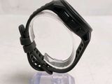someone is holding a watch in their hand on a clear stand