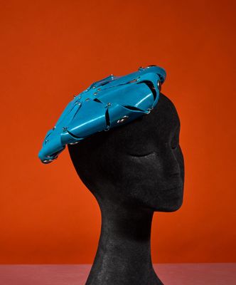 a close up of a mannequin head with a blue hat on it