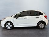 a picture of a small white car parked in a garage