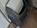 a mop and a bucket on the floor in a bathroom