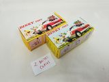 two boxes of pinky toys sitting on a table