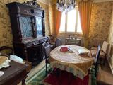 a dining room with a table, chairs, and a china cabinet