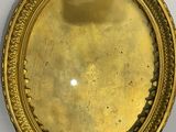a picture of a gold plate on a white wall