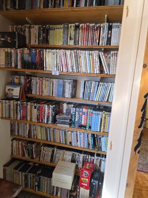 a book shelf full of books in the corner of a room