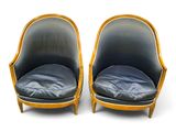 pair of mid - century style chairs with leather upholstered seats