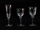three empty wine glasses are lined up against a black background