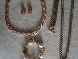 a necklace, bracelet, and earrings that are on a table