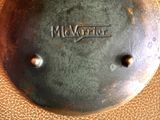 a close up of a metal object with a tag on it