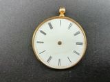 a gold clock with roman numerals on the face of it