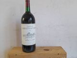 a bottle of wine that is sitting on a wooden box