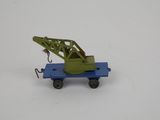 a toy truck with a crane on it on a white surface