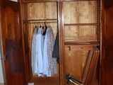 a closet with clothes hanging on it in a room