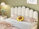 a white bed with a sunflower on it in a room
