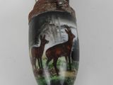 a vase that has a picture of a deer on it