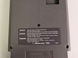 the back side of a nintendo game console with a button on it