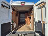 a white van with a door open in a parking lot