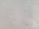 a close up of a bed with a white sheet on it