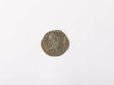 an old coin on a white surface with a white background
