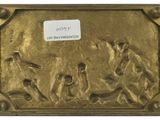 an image of a gold plate with a picture of a group of people on it
