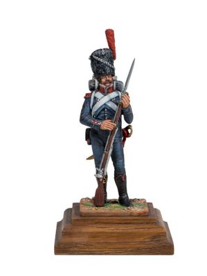 a statue of a soldier with a rifle on a wooden base