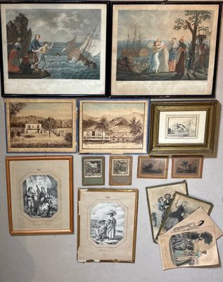 many framed pictures on the wall of a room