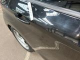 a black car with a sticker on the side of it ' s door