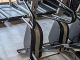 a row of stationary exercise bikes in a gym