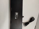 a close up of a laptop on a white surface with a charger