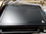 a laptop computer sitting on top of a pile of plastic wrap