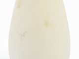 a white vase with a yellow rim sitting on a white surface