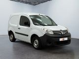 the small white van is parked in a large room