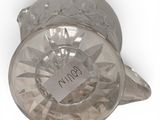 a glass candle holder that has a label on it