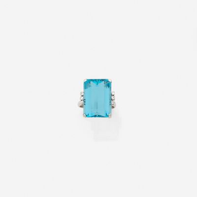a blue topaz stone and diamond ring on a white background