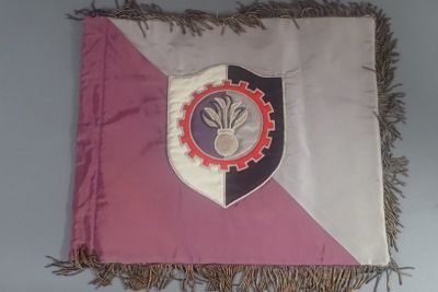 a pink and white flag with a crest on it