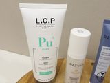a bottle of lotion and a tube of lotion sitting on a table