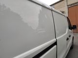 a white van that is parked in front of a building