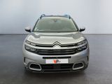 the front view of a silver citrole parked in a showroom