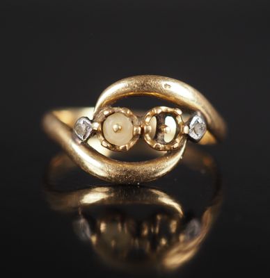 an image of a gold ring with two white diamonds
