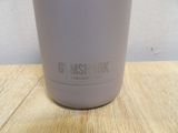 a cup that is sitting on a wooden table