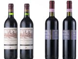 three bottles of red wine are lined up on a white surface