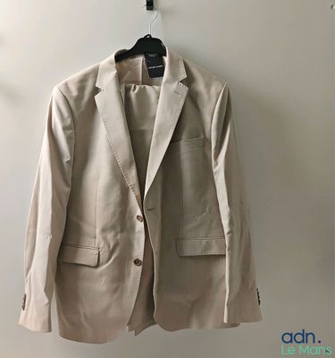 jacket hanging on a hanger on a wall in a room