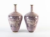 two vases that are sitting side by side on a white surface