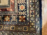 an image of a rug on a wooden floor with a cat laying on it