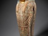an ancient egyptian statue of a woman with a bird on her head