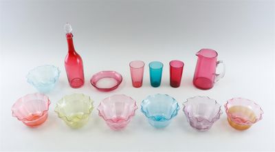 many different colored glasses and a toothbrush in a row