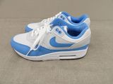 a pair of blue and white sneakers on the floor