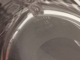 a glass bowl with a silver lid on a table