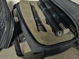 a black bag with a pen and a pair of scissors in it